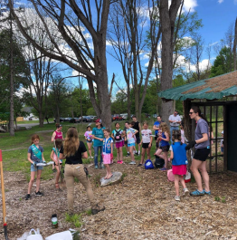 picture of staff with girl scouts planting trees