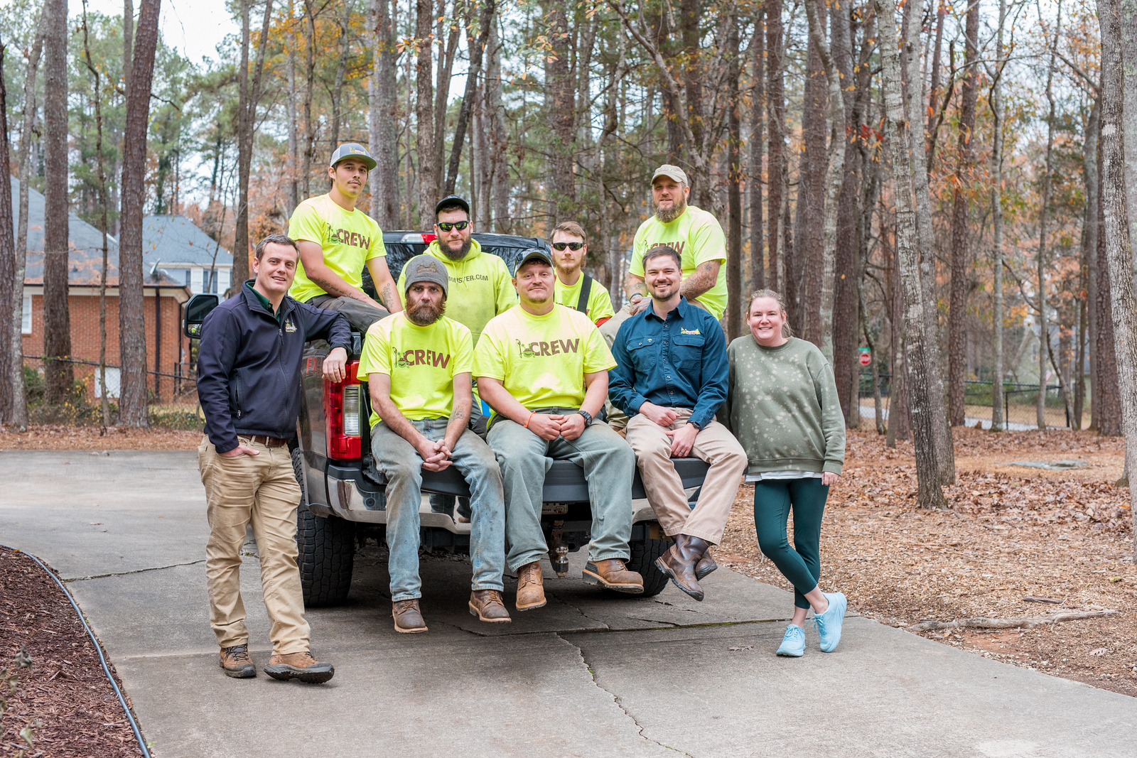 Image of Monster Tree Service of Athens Team sitting on truck bed